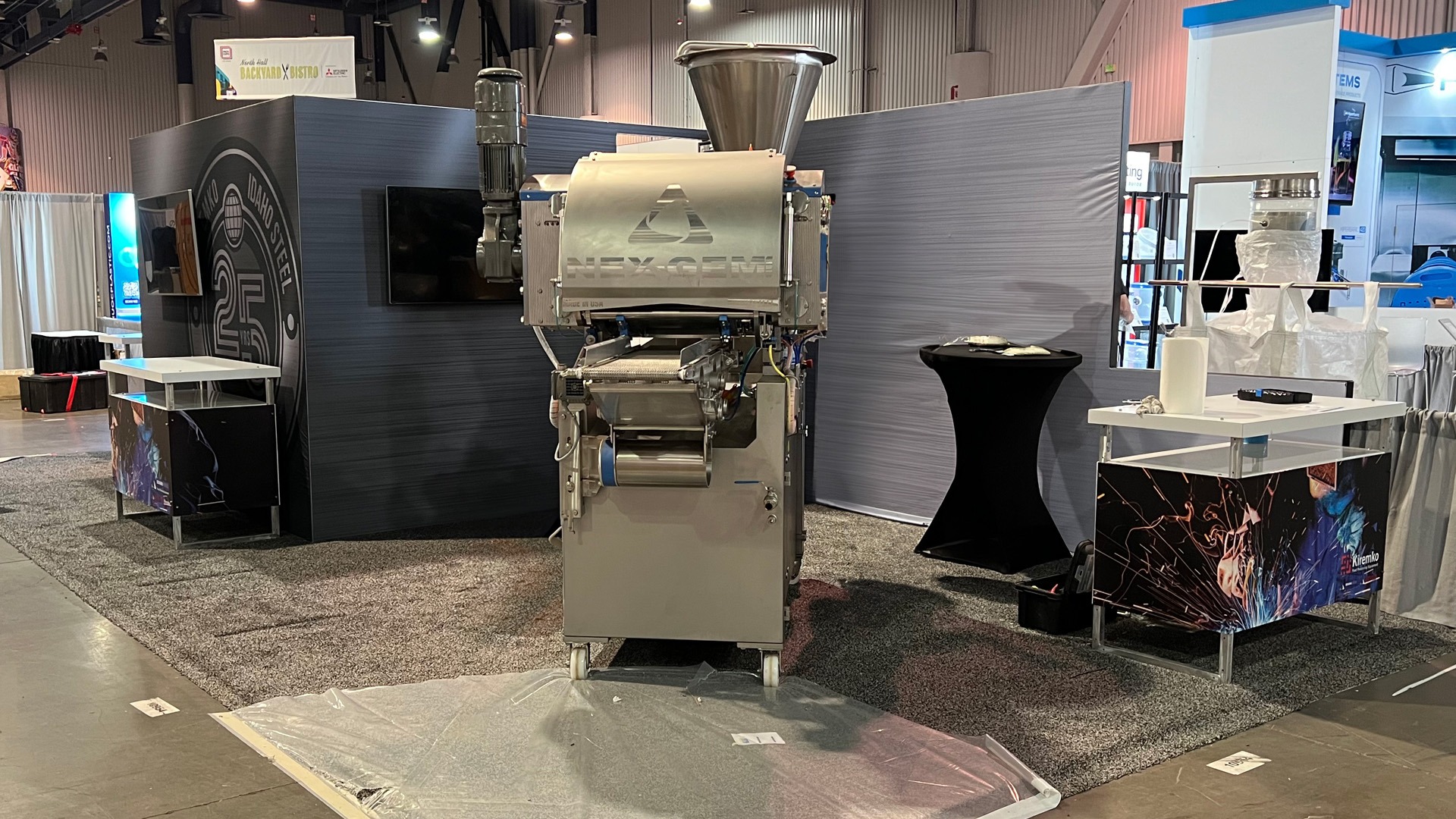 Image of a large metal steel working machine for Idaho Steel's trade show booth at Pack Expo 2023 in Las Vegas, NV, United States.
