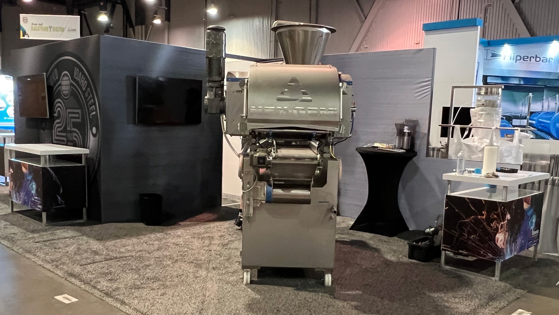 Image of a large metal steel working machine for Idaho Steel's trade show booth at Pack Expo 2023 in Las Vegas, NV, United States.